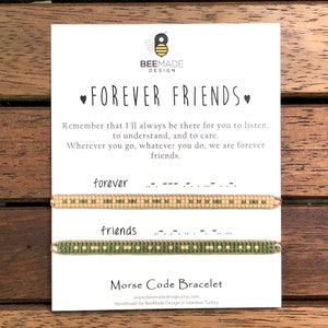 May include: Two friendship bracelets with green and beige woven bands. The bracelets are labeled "forever" and "friends" in Morse code. The card reads "Forever Friends. Remember that I'll always be there for you to listen, to understand, and to care. Wherever you go, whatever you do, we are forever friends. Morse Code Bracelet www.beemadedesign.etsy.com Handmade by BeeMade Design in Istanbul, Turkey"