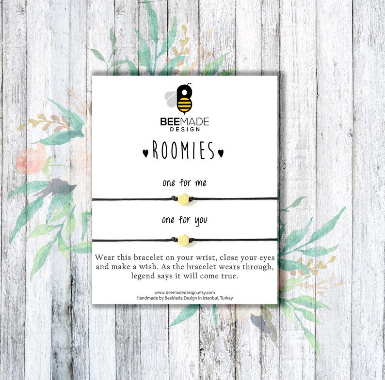 May include: A white card with black text that reads "BEEMADE DESIGN ROOMIES one for me one for you" and a small bee illustration. The card also includes the text "Wear this bracelet on your wrist, close your eyes and make a wish. As the bracelet wears through, legend says it will come true." and a website address.