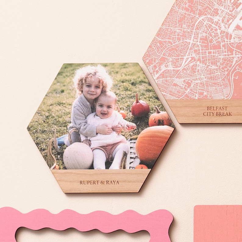 Modern illustrated map wall in solid colours and cherry wood, partnered with a custom photo tile – ideal personalised map present for marking anniversaries or travel memories.