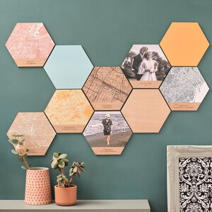 Natural wooden and colourful hexagons featuring engraved city maps – a unique map anniversary gift for a loved one. Maps teamed with plain colour blocks, and photo tiles create a stunning gallery wall.
