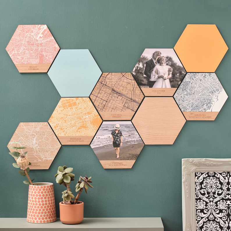 Natural wooden and colourful hexagons featuring engraved city maps – a unique map anniversary gift for a loved one. Maps teamed with plain colour blocks, and photo tiles create a stunning gallery wall.