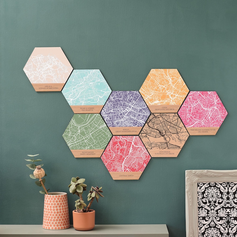 Personalised wooden map hexagons displayed on a green wall – a heartfelt 5th anniversary gift or custom map print for your first home together.