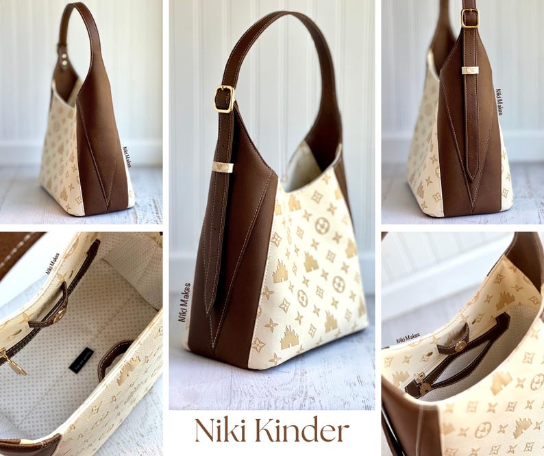 May include: A brown and cream-colored shoulder bag with a gold buckle and strap. The bag features a repeating pattern of gold icons on the cream-colored fabric. The bag has a brown leather strap and trim. The text "Niki Kinder" is at the bottom.