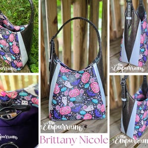 May include: A black and silver shoulder bag with a Halloween-themed pattern featuring pumpkins, ghosts, and bats. The bag has a light blue panel and a black strap. The text "Brittany Nicole" is visible.
