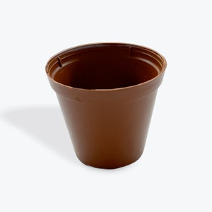 May include: A brown plastic plant pot with a slightly tapered design. The pot has a wide rim and a smooth exterior. Ideal for starting seeds or transplanting small plants. The pot is empty and ready for use.