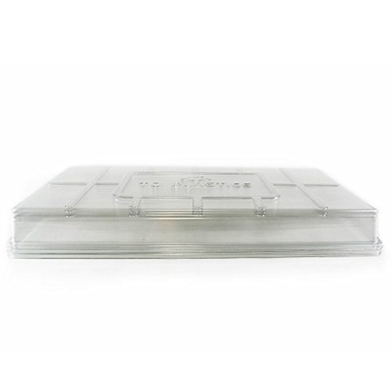 May include: A clear, rectangular plastic lid with a slightly raised edge. The lid has a grid-like pattern and a rectangular section with the text "VC SCIENCE". The lid is designed to fit over a container.