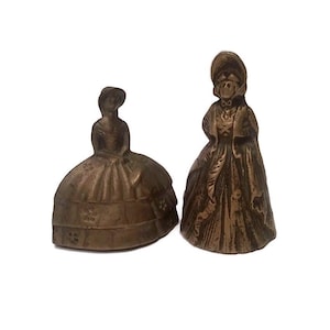 Antique brass figural lady bells