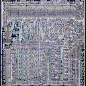 May include: Close-up view of a computer chip with intricate circuitry and a light blue and purple color scheme.