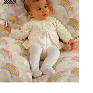 May include: A white crocheted baby cardigan with a button closure. The cardigan is made with a 3-ply botany wool yarn and is designed for a baby measuring 16 to 20 inches.