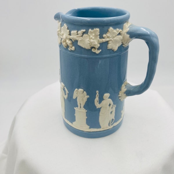 Wedgwood tiny pitcher in light blue with cream embossing, 4.75 inches tall