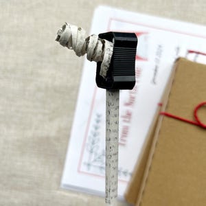 close up of a recycled newspaper pencil being sharpened