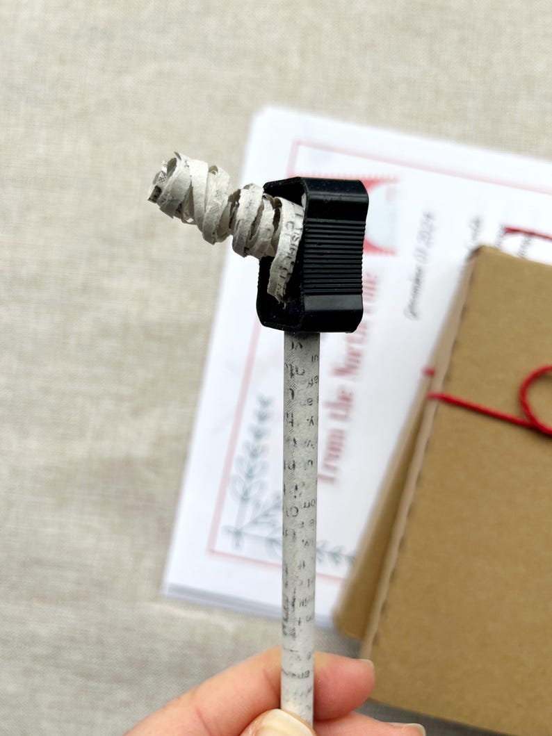 close up of a recycled newspaper pencil being sharpened