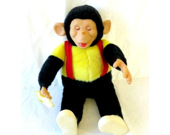 old stuffed monkey with banana in hand
