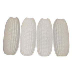 May include: Four white, oblong decorative objects with a textured, ridged surface. The objects are arranged in a row against a white background. The design resembles a stylized ear of corn.