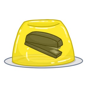 May include: A yellow gelatin dessert with a brown stapler inside. The dessert is on a white plate.