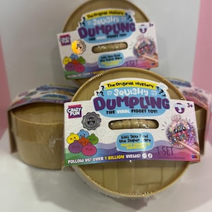 May include: Three round, tan-colored plastic containers, each featuring a label that reads The Original Mystery Squishy Dumpling The Viral Fidget Toy! Series 3. The packaging includes illustrations of colorful dumplings and a clear window showing the toy.
