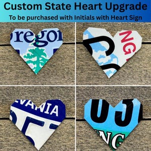 May include: Four heart-shaped decorations made from license plates. Each heart features a different state design, including "Oregon", "NG", "VANIA", and "UJ NG". The text "Custom State Heart Upgrade" is at the top.