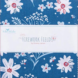 May include: A fabric square with a blue background and a white floral pattern with red accents. The text "FIREWORK FIELDS" is displayed on a white label, along with the designer's name.