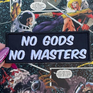 May include: Black embroidered patch with white text that reads "NO GODS NO MASTERS".