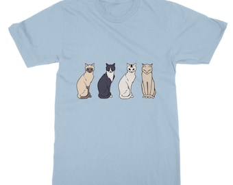 May include: A light blue t-shirt featuring a graphic of four cats sitting in a row. The cats are all different colours and have different facial expressions.