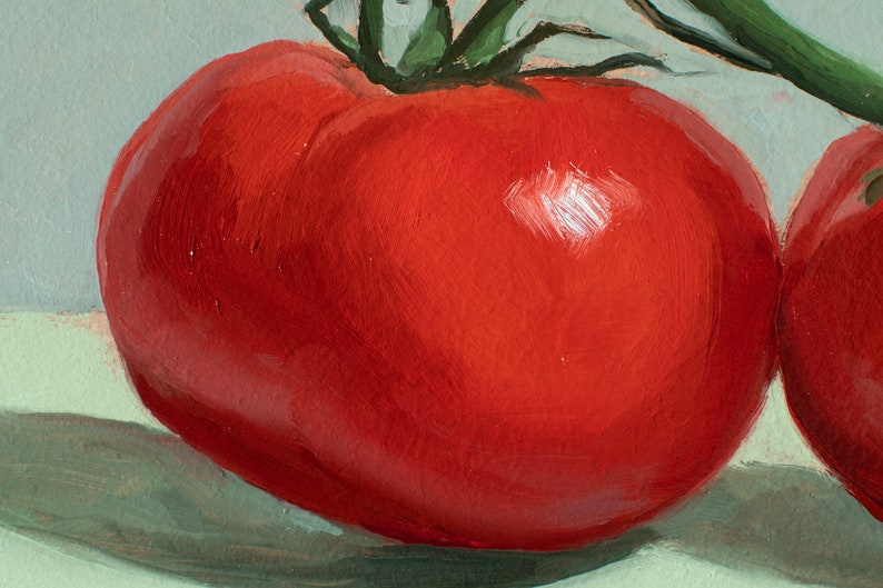 May include: Two red tomatoes with green stems, one in front of the other, on a light green background.