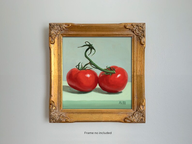 May include: A framed painting of two red tomatoes on a green vine, against a light green background. The painting is signed "AV23" in the bottom right corner.
