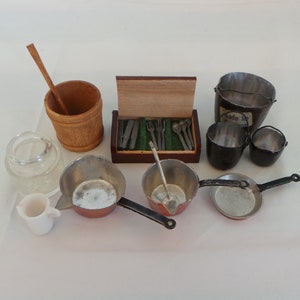 May include: A set of miniature kitchen utensils and cookware, including a wooden bucket with a wooden spoon, a box of silverware, two small pots, a frying pan, and three small metal buckets.