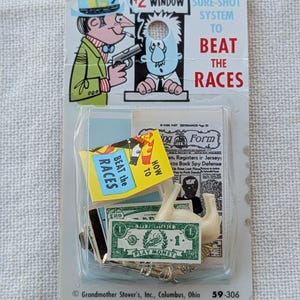 May include: Vintage novelty item in a clear plastic package. The packaging features cartoon illustrations and text that reads "$2 Window Sure-Shot System to Beat the Races." Includes play money, a newspaper clipping, and other small items. The item is from Grandmother Stover's, Inc., Columbus, Ohio.