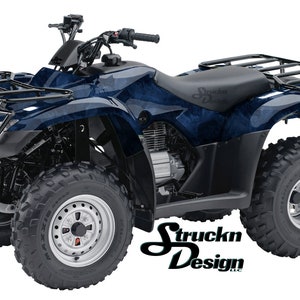 May include: A blue and black ATV with a black metal rack on the back. The ATV has a black seat and black wheels with silver rims. The ATV is on a white background.