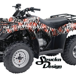 May include: A black ATV with a red, white and black zebra print design. The ATV has a black roll cage and a black seat. The ATV is on a white background.