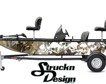 Puede incluir: Una envoltura de barco de camuflaje blanco y marrón con un diseño de calavera. El barco está en un remolque con un logotipo en blanco y negro que dice "Struckn Design LLC".