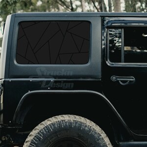 May include: Black Jeep Wrangler with a black geometric window tint. The rear window has a large geometric pattern, while the side window has a smaller pattern.