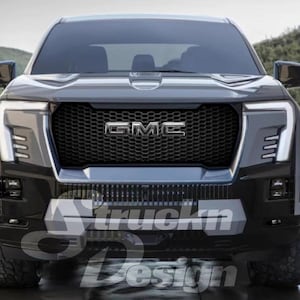 May include: Front view of a GMC truck with a black grille and the GMC logo. The truck has a gray body, black accents, and large headlights. The image has the text "truckn Design" at the bottom.