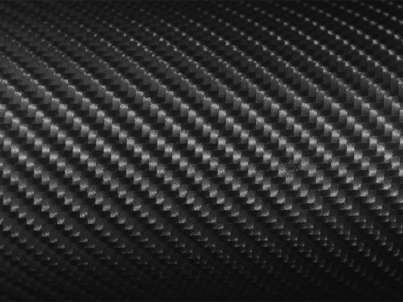 May include: Black carbon fiber textured vinyl sheet. The sheet has a subtle sheen and a repeating pattern of diagonal lines.