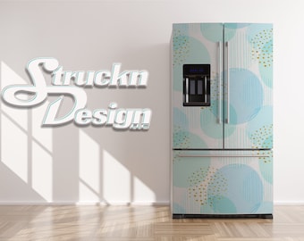 May include: A white refrigerator with a blue and gold geometric pattern. The pattern features large circles with a light blue watercolor effect and gold dots. The refrigerator has a double door design with a freezer on top.