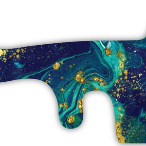 May include: A teal and gold marbled pattern on a vinyl sticker for a planner or journal.