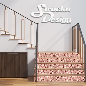 May include: Red and white patterned stair treads with a black railing and a white wall with the text "Struckn Design" in a teal blue font.