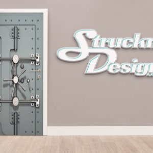 May include: A gray metal door with a large, round, silver knob and multiple silver bars and hinges. The door has a textured surface and is set against a light gray wall. The text "Struckn Design" is visible in white letters on the wall.