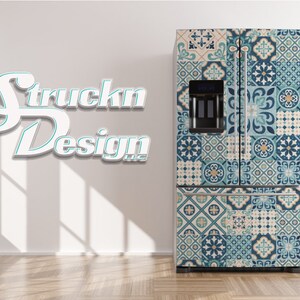 May include: A white refrigerator with a blue and beige patterned design. The design features a variety of geometric shapes and floral motifs. The refrigerator is in a room with a white wall and a wooden floor.
