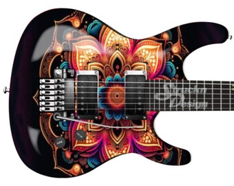 Puede incluir: Una guitarra eléctrica negra con un diseño de mandala colorido en el cuerpo. El mandala presenta detalles intrincados en tonos de rojo, naranja, amarillo, azul y verde.