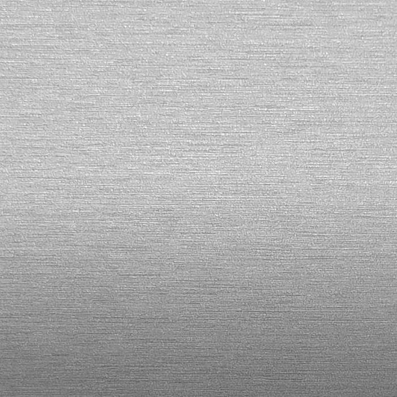 May include: A close-up of a silver textured surface with a subtle brushed finish.
