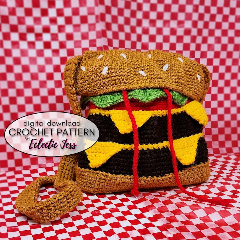 May include: Crochet pattern for a hamburger-shaped bag. The bag is brown, yellow, red, and green. The pattern is available for digital download by Eclectic Jess.
