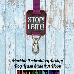 May include: Machine embroidery design for a dog leash slide, featuring the text "STOP! I BITE!" in white embroidery on a black background. The design is 4x4 inches and is digitized by hand.