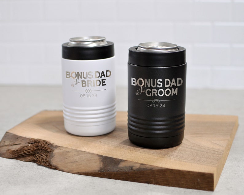 May include: Two stainless steel can coolers, one white and one black, with the text "Bonus Dad of the Bride" and "Bonus Dad of the Groom" and the date "08.15.24" engraved on them.