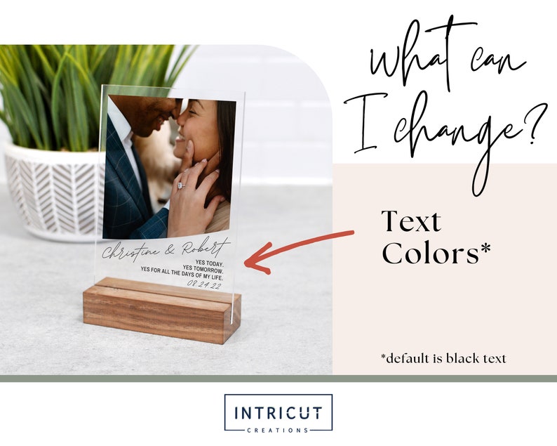 May include: A clear acrylic photo display with a wooden base. The display features a couple's photo and text that reads "Christine & Robert, YES TODAY, YES TOMORROW, YES FOR ALL THE DAYS OF MY LIFE, 08.24.22". Additional text on the right says "what can I change? Text Colors*" with "*default is black text".