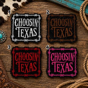 May include: Four square embroidered patches on a wooden surface, each featuring the text 'CHOOSIN' TEXAS' in a stylized font. The patches are black with a barbed wire border. The text and border colors are white, brown, red, and bright pink.