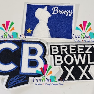 May include: Embroidered patches with different designs. One patch shows a silhouette and the word "Breezy" on a blue background. Another patch has "CB" in white and blue. A third patch says "Breezy Bowl XX".