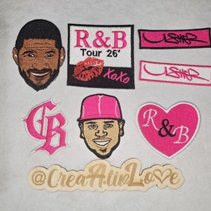 May include: A selection of embroidered patches with various designs. These include portraits of a smiling man, a pink heart with "R&B", and text that reads "R&B Tour 26' Xoxo". Other patches feature the name "Usher" in a stylized font.