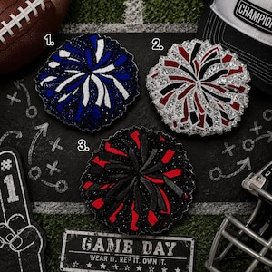 May include: Three circular cheerleading pom-pom patches with glittery textures. Patch 1 is blue and white, patch 2 is red, black, and silver, and patch 3 is black and red. Each patch features a radial design of layered, fringed fabric strips.