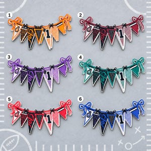 May include: Six sets of pennant banners in orange, maroon, purple, teal, red, and blue. Each banner features five triangular flags with patterns including a foam finger, the word Go, a number 1, and stripes, all tied with black bows.